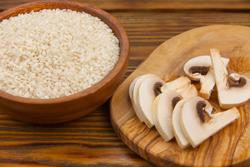 Tasty appetizing risotto on  white plate on  wooden table