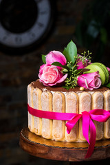 Beautiful elegant cake.Decorated biscuits savoyardy marcaroni,flowers ,bow.Handmade work.Wooden high stand