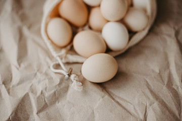 Farm eggs in eco natural bag on craft paper background.
