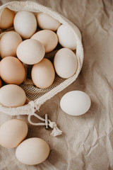 Farm eggs in eco natural bag on craft paper background.