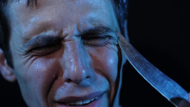 A criminal threatens a scared hostage