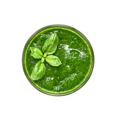 Glass of green smoothie decorated with basil leaves, isolated over white with clipping path. Top view