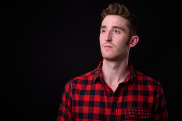 Face of young handsome hipster man thinking