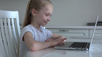 European blonde happy girl sitting at laptop at home, using zoom learning online meeting app, social distancing, homeschooling education, covid-19 coronavirus concept