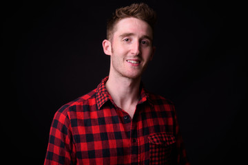 Face of happy young handsome hipster man smiling