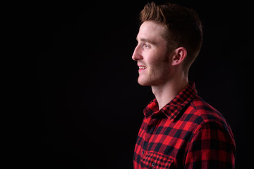 Closeup profile view of happy young handsome hipster man smiling
