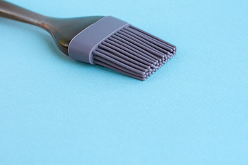 Cooking silicone brush on a blue background.