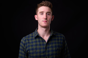 Face of young handsome hipster man looking at camera