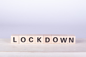 wooden cubes building the word Lockdown, white background