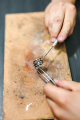 Master goldsmith working at golden ring. Jewelry, craft, handmade concept .