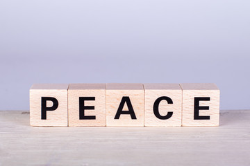 wooden cubes building the word Peace, white background