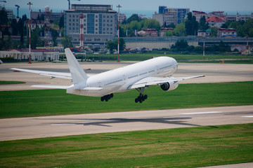 a big white plane takes off in the sunlight. start of vacation