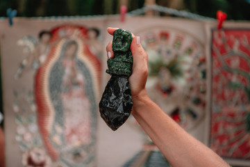 Mayan obsidian sacrifice knife in a female hand.