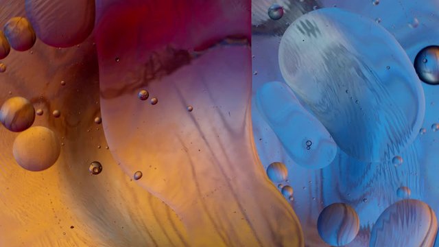 Oil drops on a water surface abstract background. Abstract colorful background. Foam of Soap with Bubbles macro shot. Closeup bubbles in water. Golden yellow bubble.