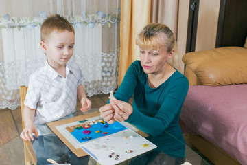 in quarantine, grandson and grandmother engaged in modeling from plasticine