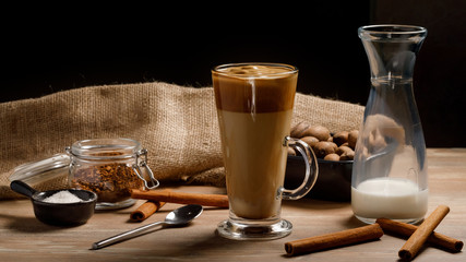 Dalgona coffee - the Korean coffee drink on wooden background. Instant coffee or espresso powder whipped with sugar and hot water. Iced whipped dalgona coffee concept.