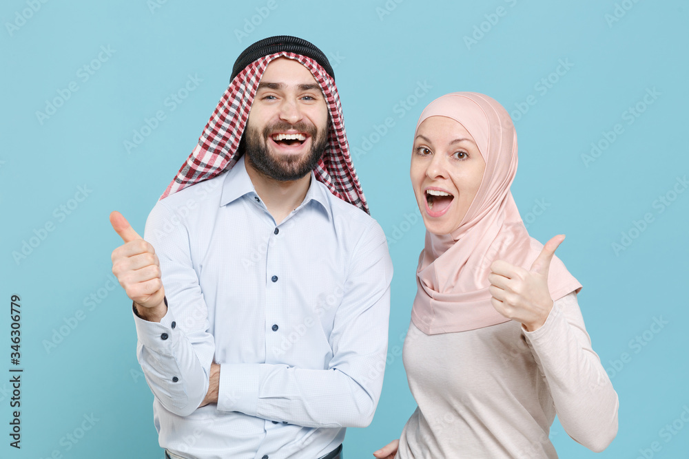 Wall mural cheerful young couple friends arabian muslim man wonam in keffiyeh kafiya ring igal agal hijab cloth