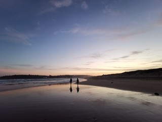 Fototapeta na wymiar Reflection of two ladies on the Dee Why Beach, Sydney Australia