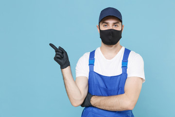 Delivery man in cap t-shirt coveralls uniform sterile face mask gloves isolated on blue background studio. Guy employee courier Service quarantine pandemic coronavirus virus covid-19 2019-ncov concept