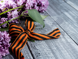 Concept holiday on may 9, victory Day. St. George's ribbon and lilac branches as symbols of victory.