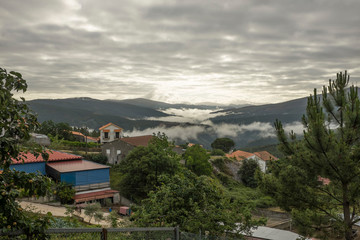 Overlooking Esporao village and countryside in rural Portugal wih low stratus clouds in the valleys - obrazy, fototapety, plakaty