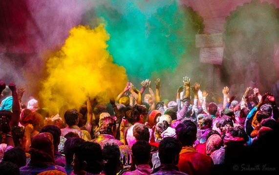 People Playing With Powder Paint On Street During Holi