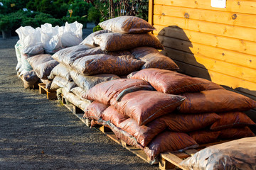 tree bark for landscaping in bags for sale on pallets in a garden center