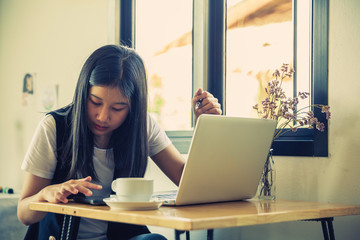 Young woman sits in coffee shop at table