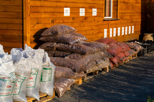 tree bark for landscaping in bags for sale on pallets in a garden center