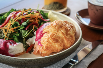 Breakfast with poached eggs and butter croissant