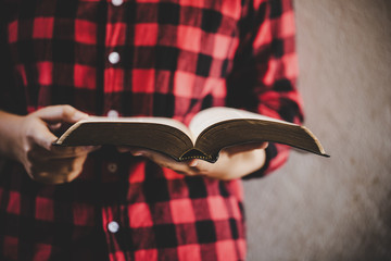 girl hands while reading the Bible.