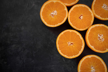 Halves of juicy orange on a rustic background