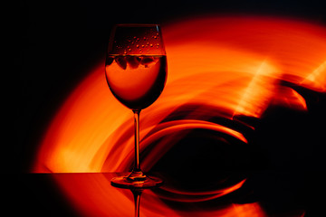 Glass for wine against the backdrop of bright color solutions 