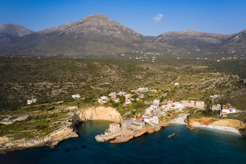 Obraz premium Aerial birds eye view photo taken by drone of fishing village of Mezapos with blue clear waters, Mani, Laconia, Peloponnese, Greece