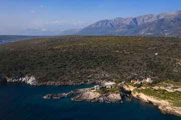 Fototapeta na wymiar Aerial birds eye view photo taken by drone of fishing village of Mezapos with blue clear waters, Mani, Laconia, Peloponnese, Greece