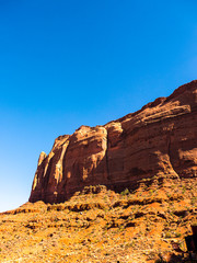 Fototapeta premium Monument Valley provides perhaps the most enduring and definitive images of the American West. The isolated red mesas and buttes are surrounded by empty, sandy desert 