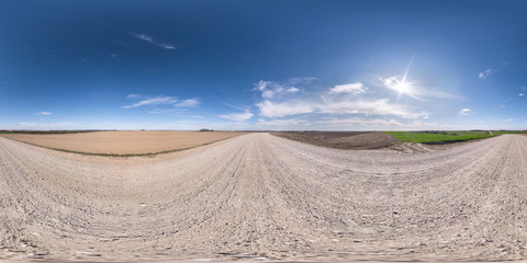 Fototapeta na wymiar full seamless spherical hdr panorama 360 degrees angle view on white sand gravel road among fields in spring day with awesome clouds in equirectangular projection, ready for VR virtual reality content