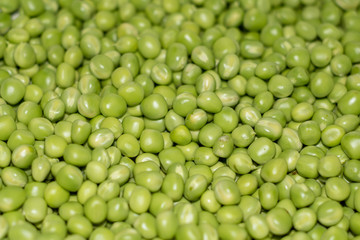 Background of young juicy green peeled peas