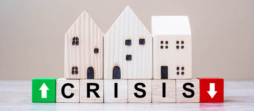 CRISIS Cube Blocks With Wooden House Model On Table Background. Coronavirus Pandemic, Fall Business, Unemployment, Economic Recession, Developer, Real Estate And Property Concept