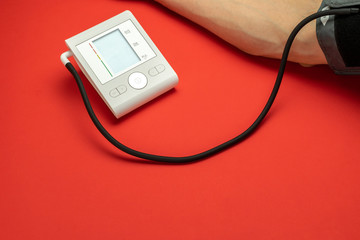Pressure meter. Patient test hypertension from medical sphygmomanometer. Health monitor for check doctor blood pressure isolated on red background. Man hand cardio control.