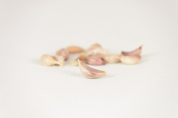 Fresh garlic cloves on white canvas background with copy space. select focus