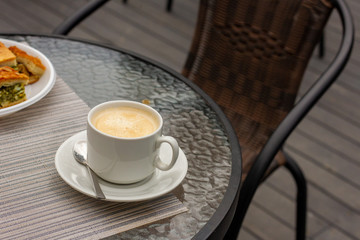 Mug of coffee in a summer cafe. Luxury rest.