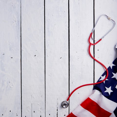 Obraz na płótnie Canvas American Flag With Stethoscope On Table