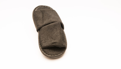 Comfy plush hotel amenity slippers isolated against white background.  