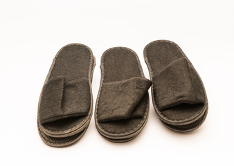 Comfy plush hotel amenity slippers isolated against white background.  