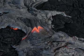 Hot lava and solid ash as seen from above