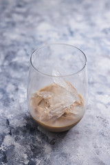 glass of Irish cream liqueur with sharp blocks of ice shot