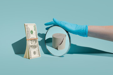 A pack of dollars is standing in front of the mirror. Mirror reflection of empty paper. The concept of inflation and crisis during the coronavirus