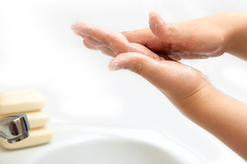 Obraz na płótnie Canvas clean children's hands in soap wash in water