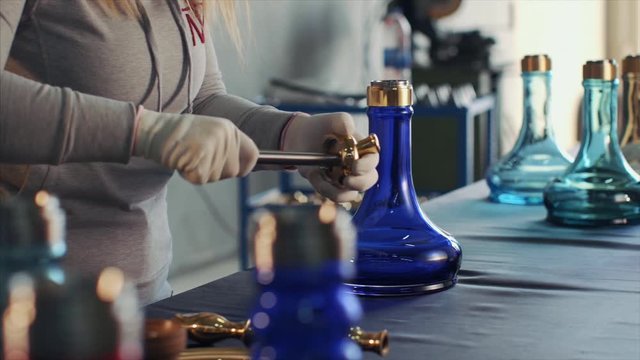 hookah making. woman combines hookah parts.
